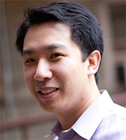 A headshot of Roger Peng, an Asian man with short dark hair, facing left.