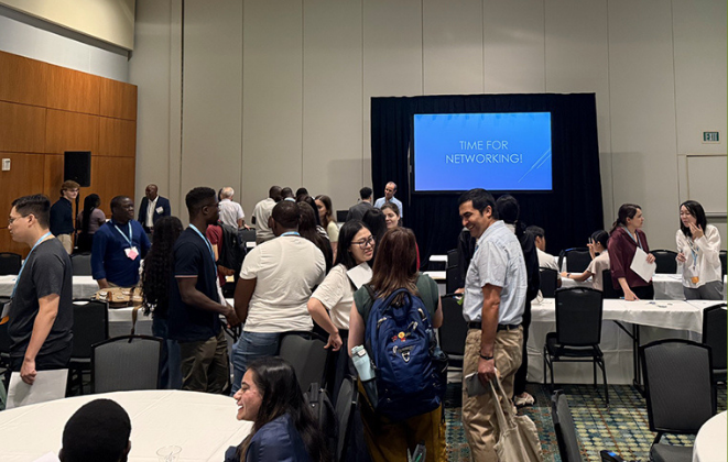 A conference room full of people talking to each other.