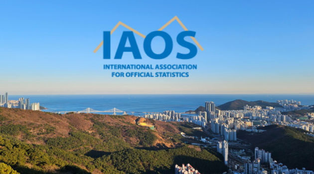IAOS logo that has a yellow line behind the letters IAOS. It's sitting in the front of a drone shot of Busan Korea