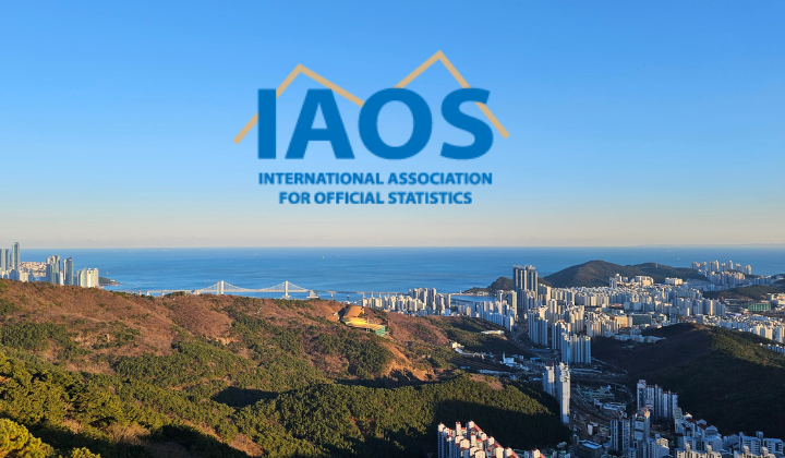 IAOS logo that has a yellow line behind the letters IAOS. It's sitting in the front of a drone shot of Busan Korea