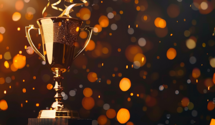 Trophy with sparkling confetti in the background