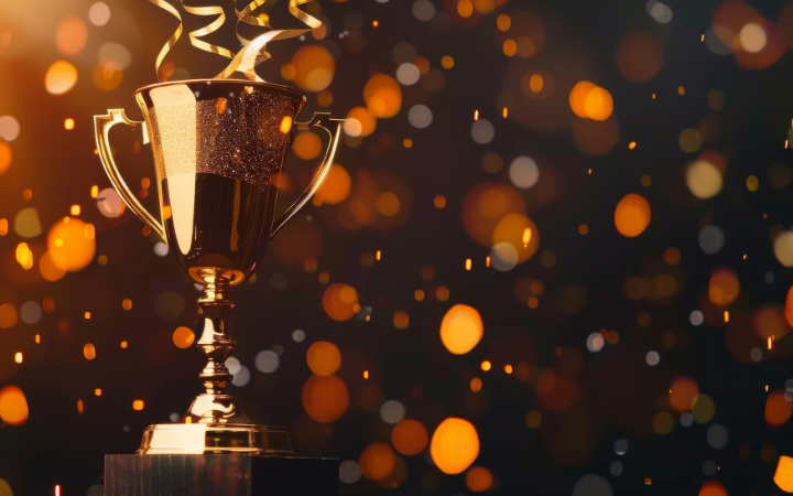 Trophy with sparkling confetti in the background