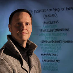 Man with short hair, looking up, long neck, slight smile