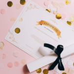 A certificate and a rolled up piece of paper tied with a ribbon