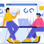 One person teaching another in front of data charts.
