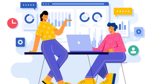 One person teaching another in front of data charts.