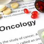 A paper that says "oncology" and several different pills.