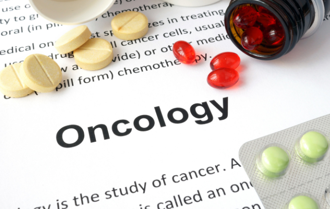A paper that says "oncology" and several different pills.