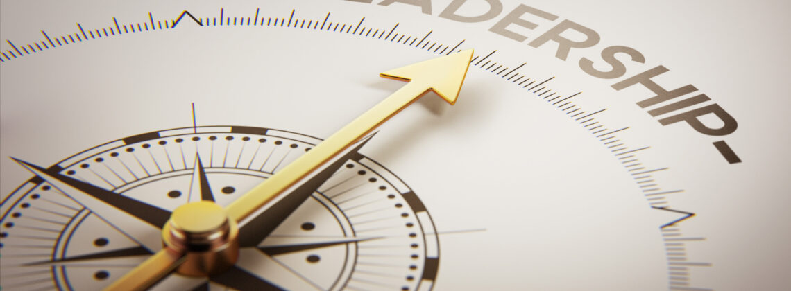 Golden compass with arrow pointing to the word leadership