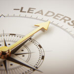 Golden compass with arrow pointing to the word leadership