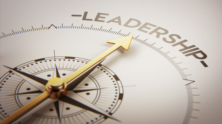 Golden compass with arrow pointing to the word leadership