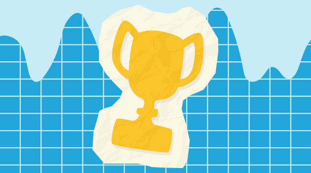 A paper trophy on top of a graph paper pattern.